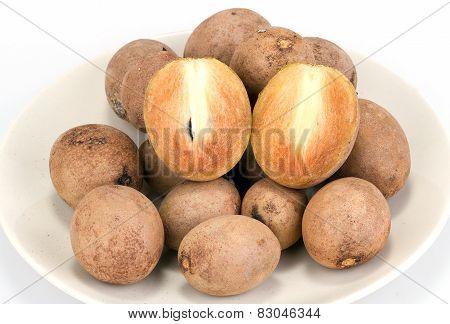 fresh sapodilla - whole and half cut