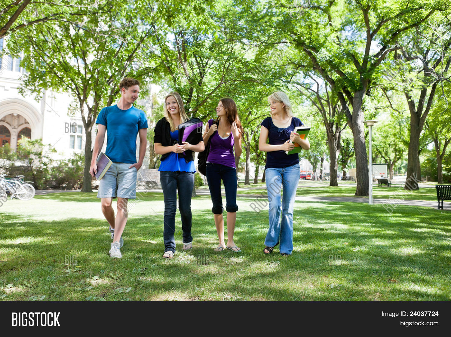 group of college students walking in campus ground
