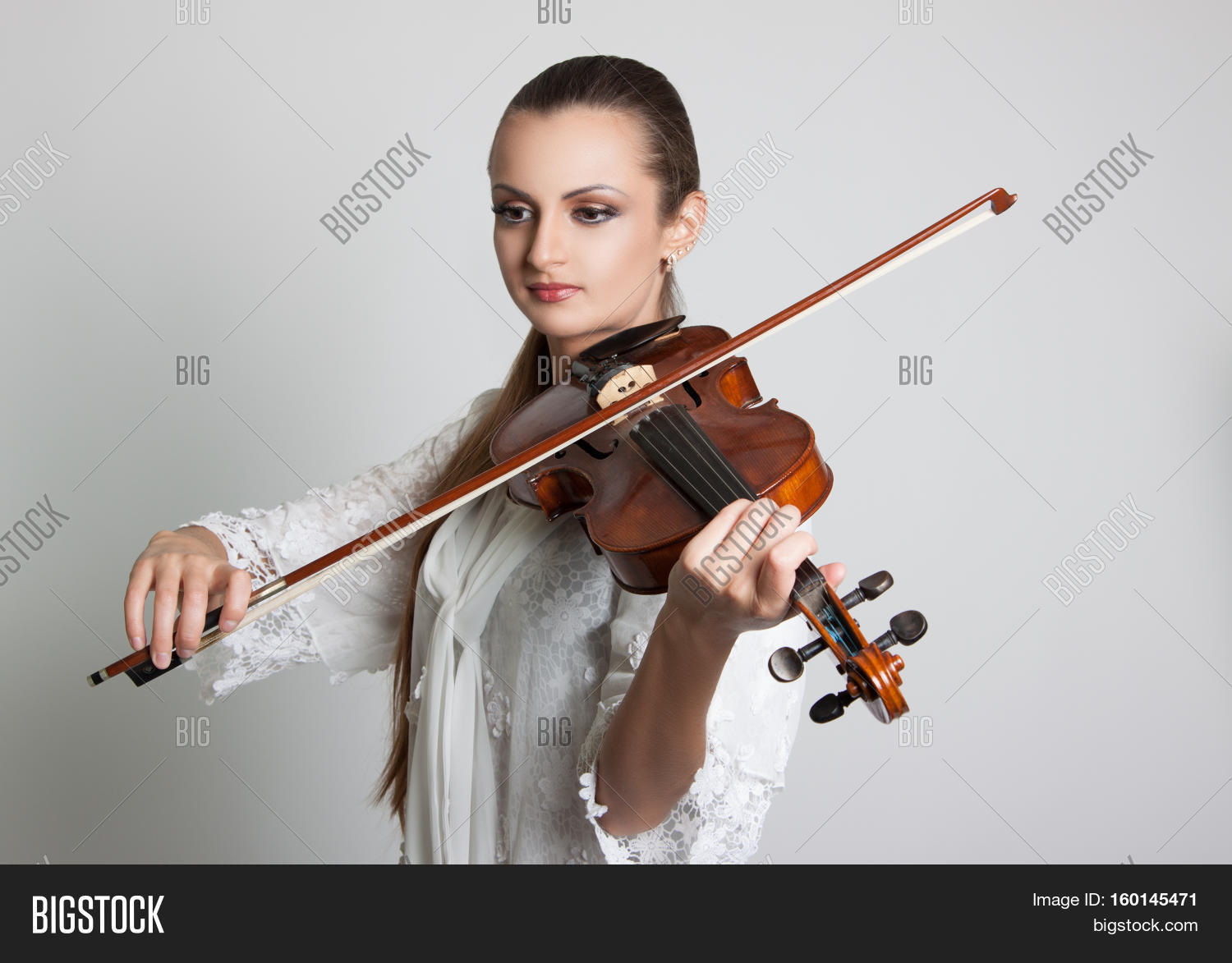 beautiful young woman playing the violin. musician.