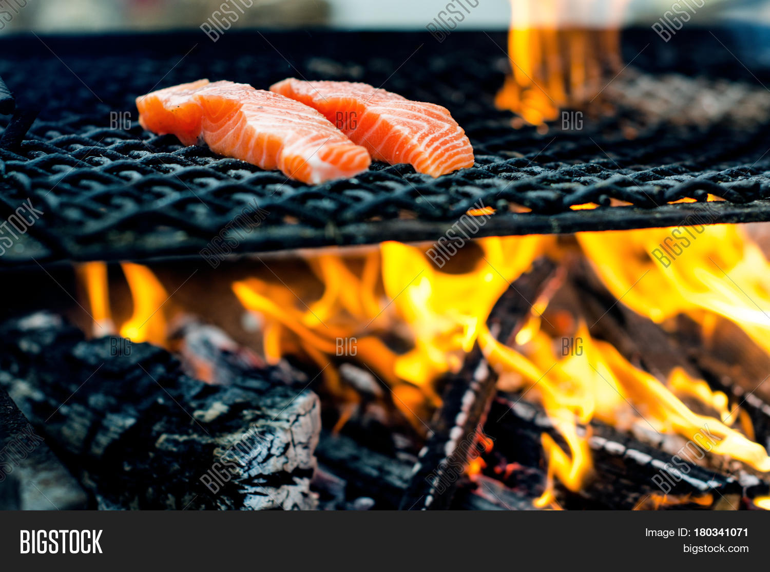 grilled salmon steaks on a grill. fire flame grill.