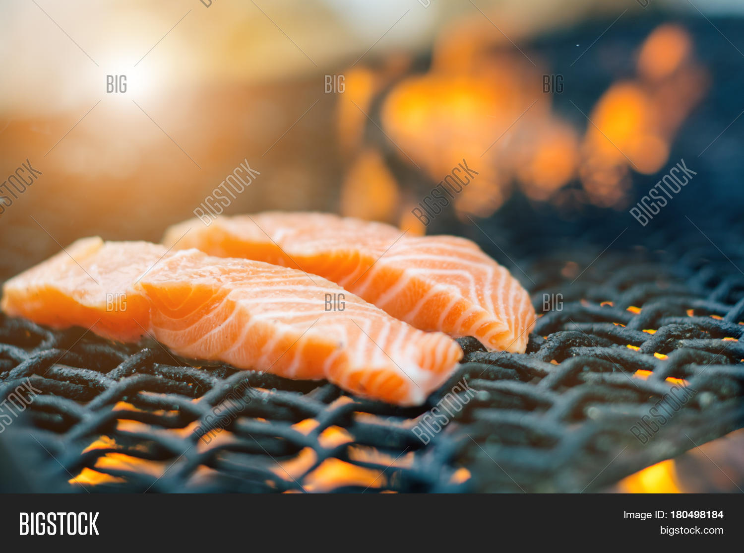 grilled salmon steaks on a grill. fire flame grill.
