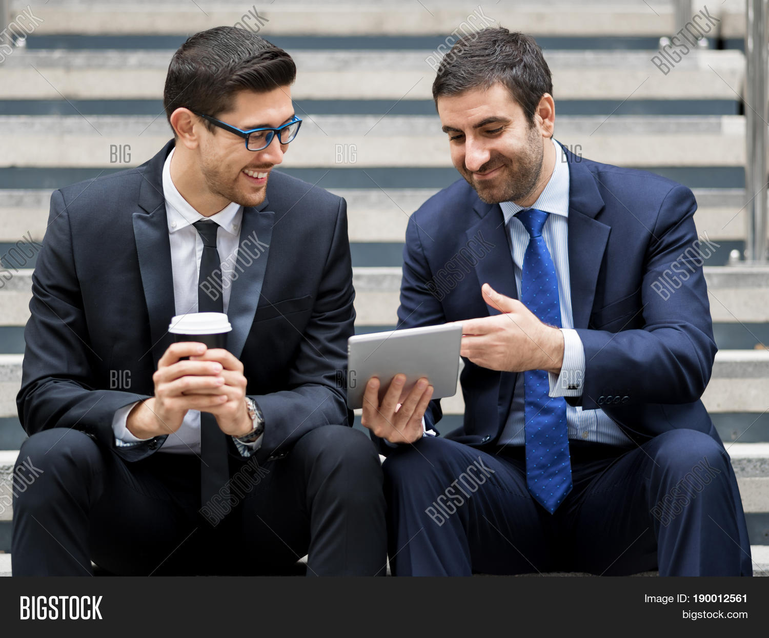 two businessmen talking outdoors