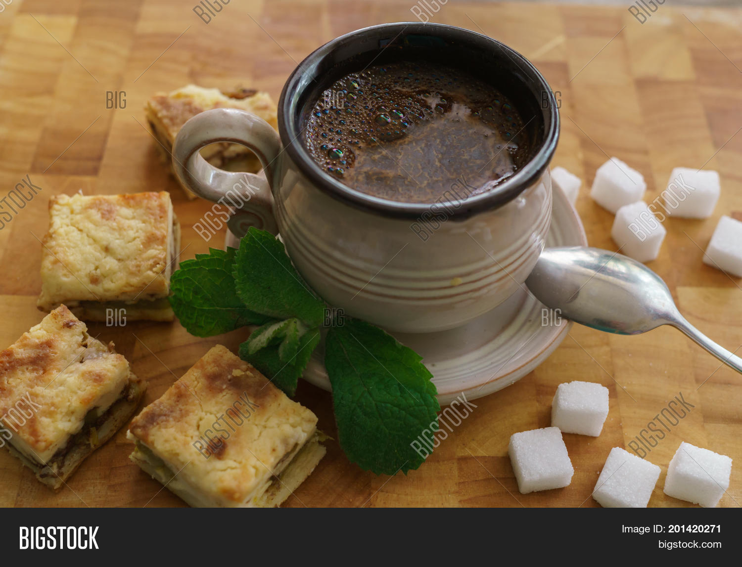 a cup of fresh coffee with pieces of cake.