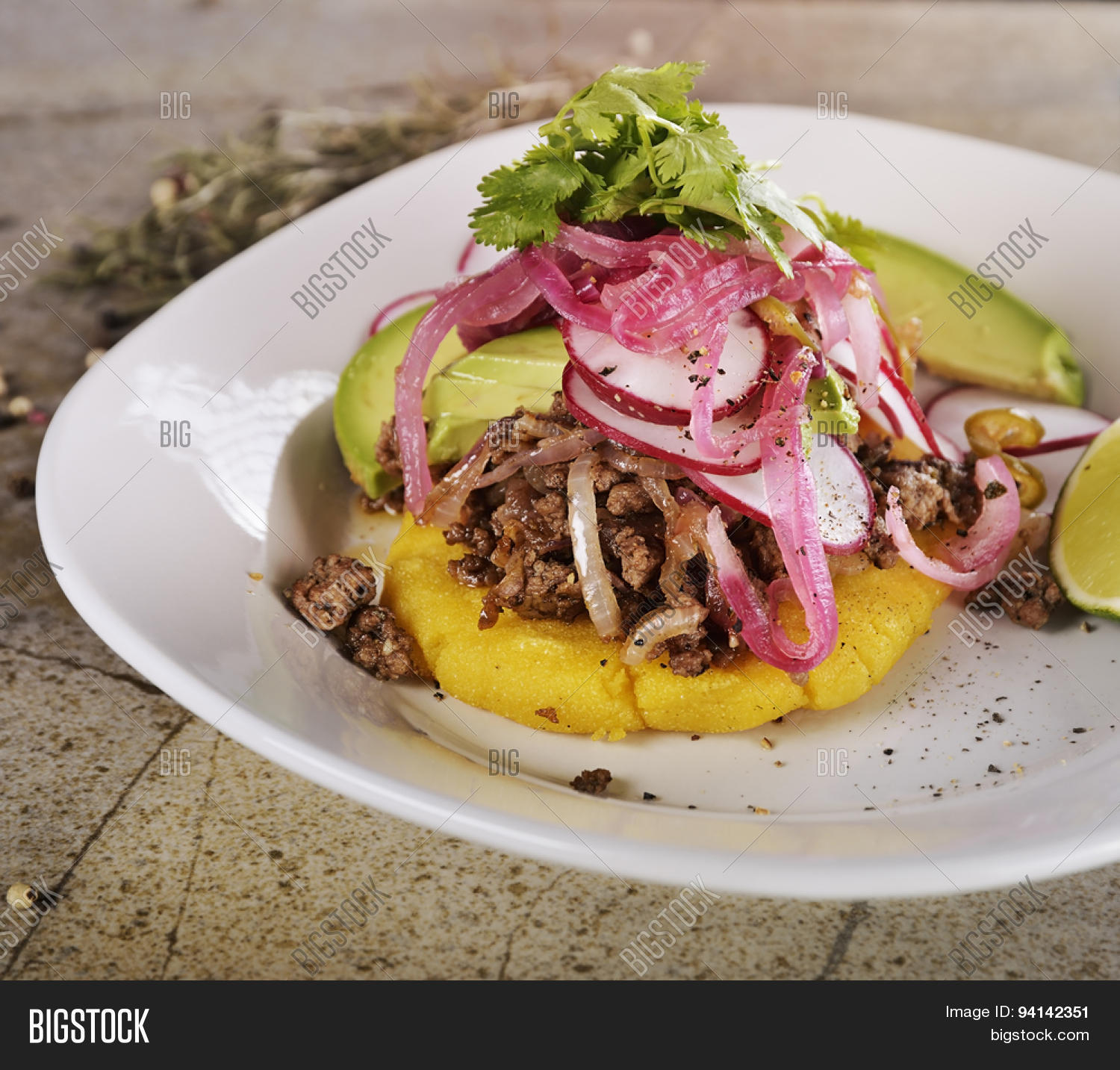 arepas, fried cornmeal patties,with ground beef,avocado,red