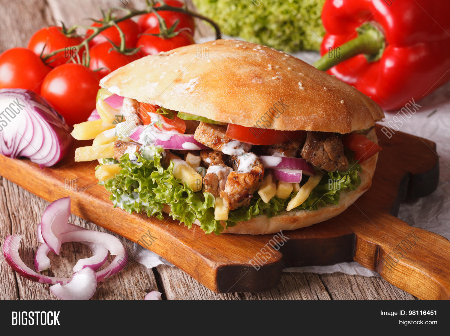 doner kebab with meat vegetables and french fries close-up on