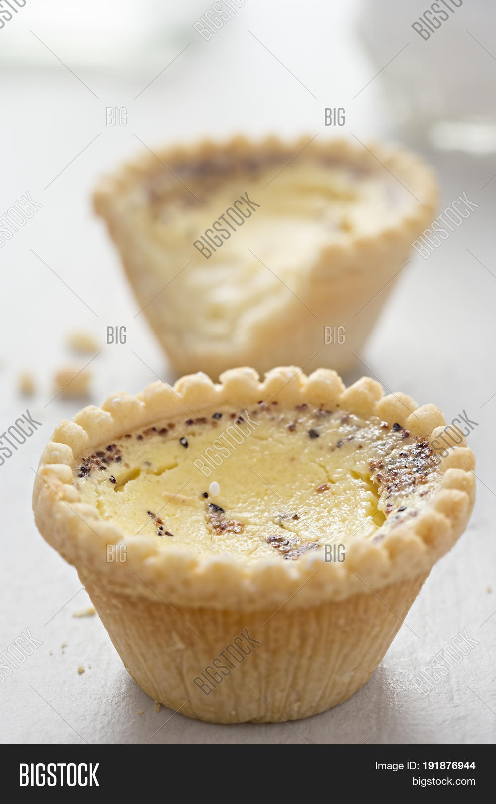 egg custard tart with nutmeg on white table