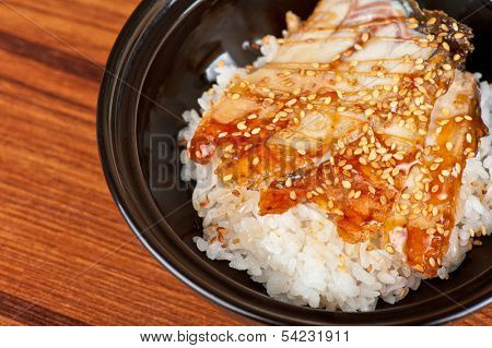 japanese cuisine, eel with rice at black plate