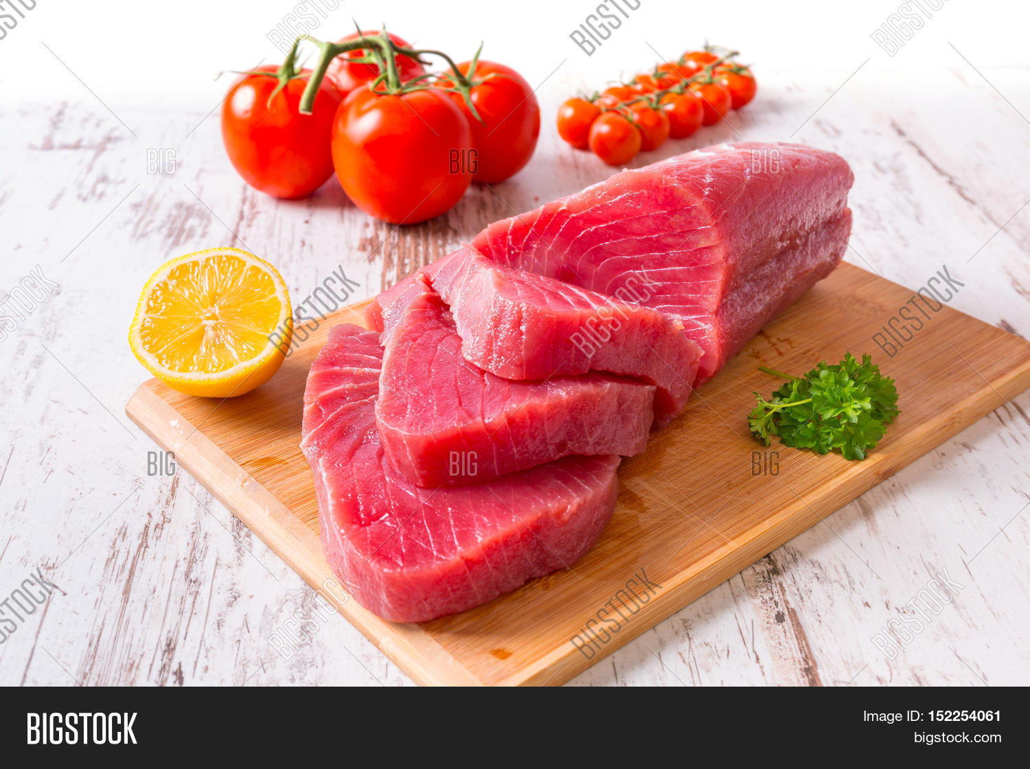 raw tuna steak on wooden cutboard