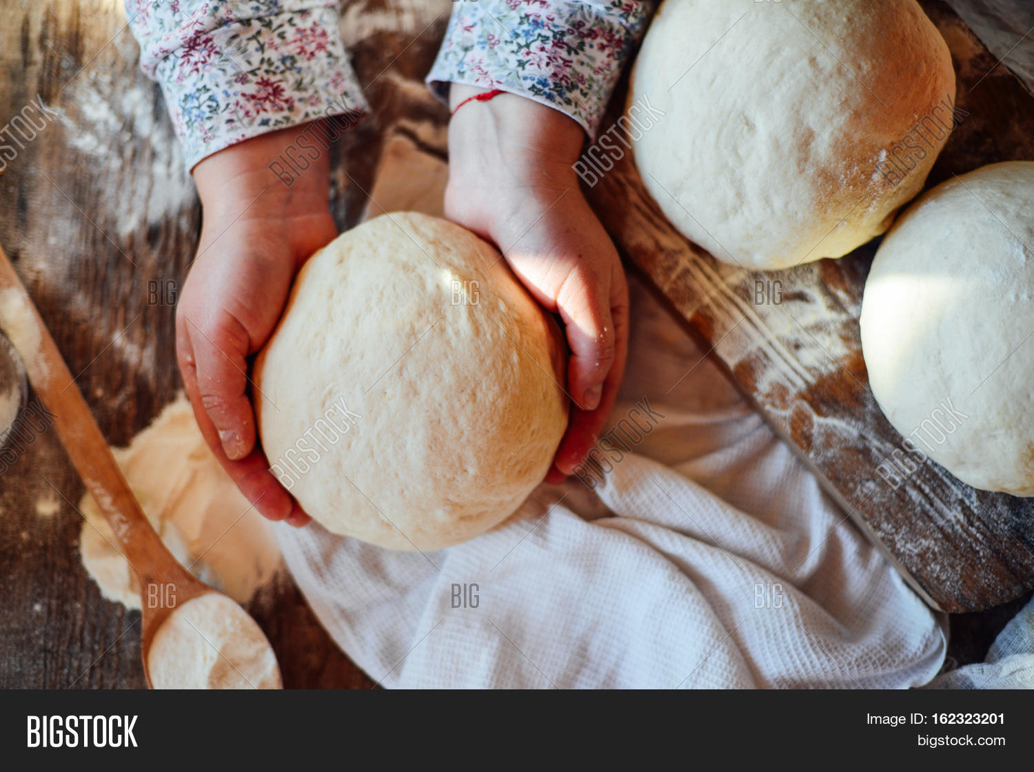 close up view of baker kneading dough. homemade bread.