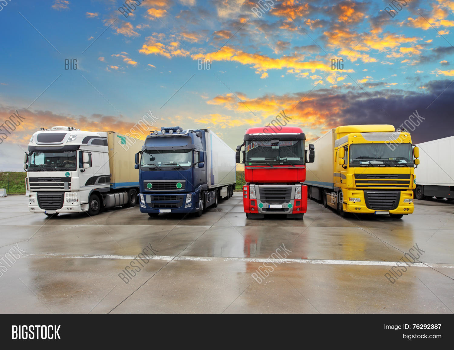 four trucks - freight transportation at a sunset