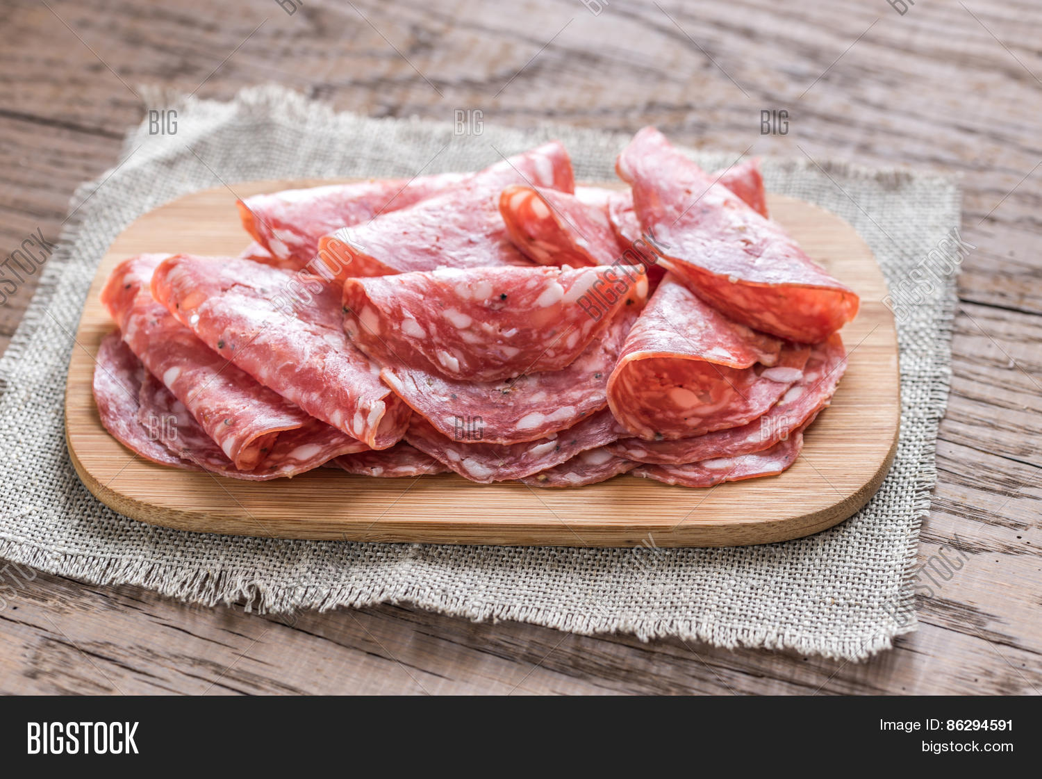 slices of salami on the wooden board
