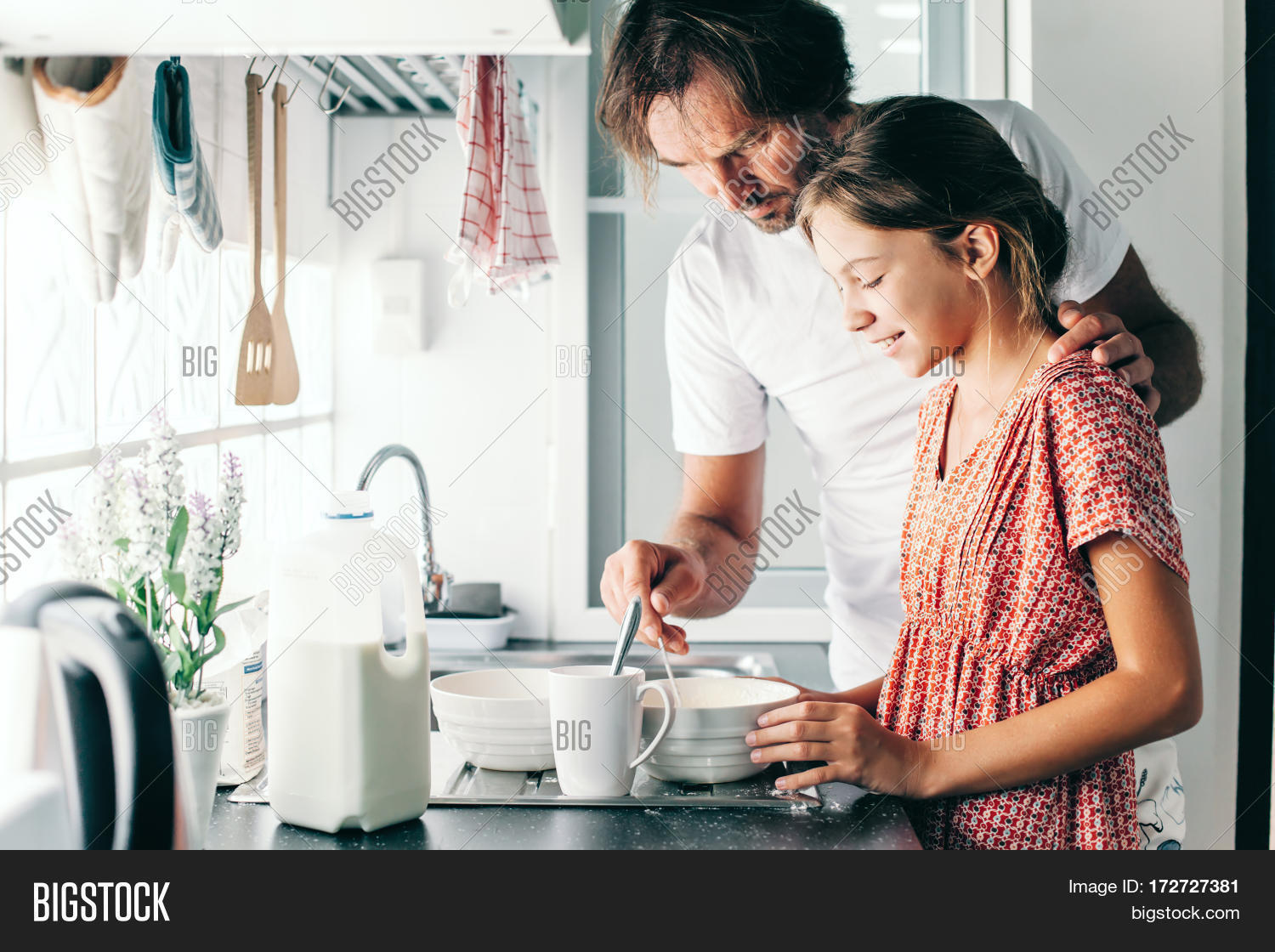his 10 years old kid girl cooking in the kitchen, casual life