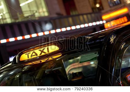 low key detail of london black cab sign turned on at night, with