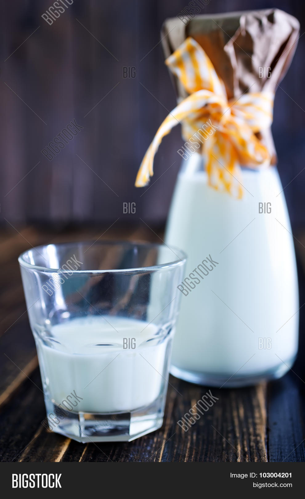 fresh milk in glass and on a table