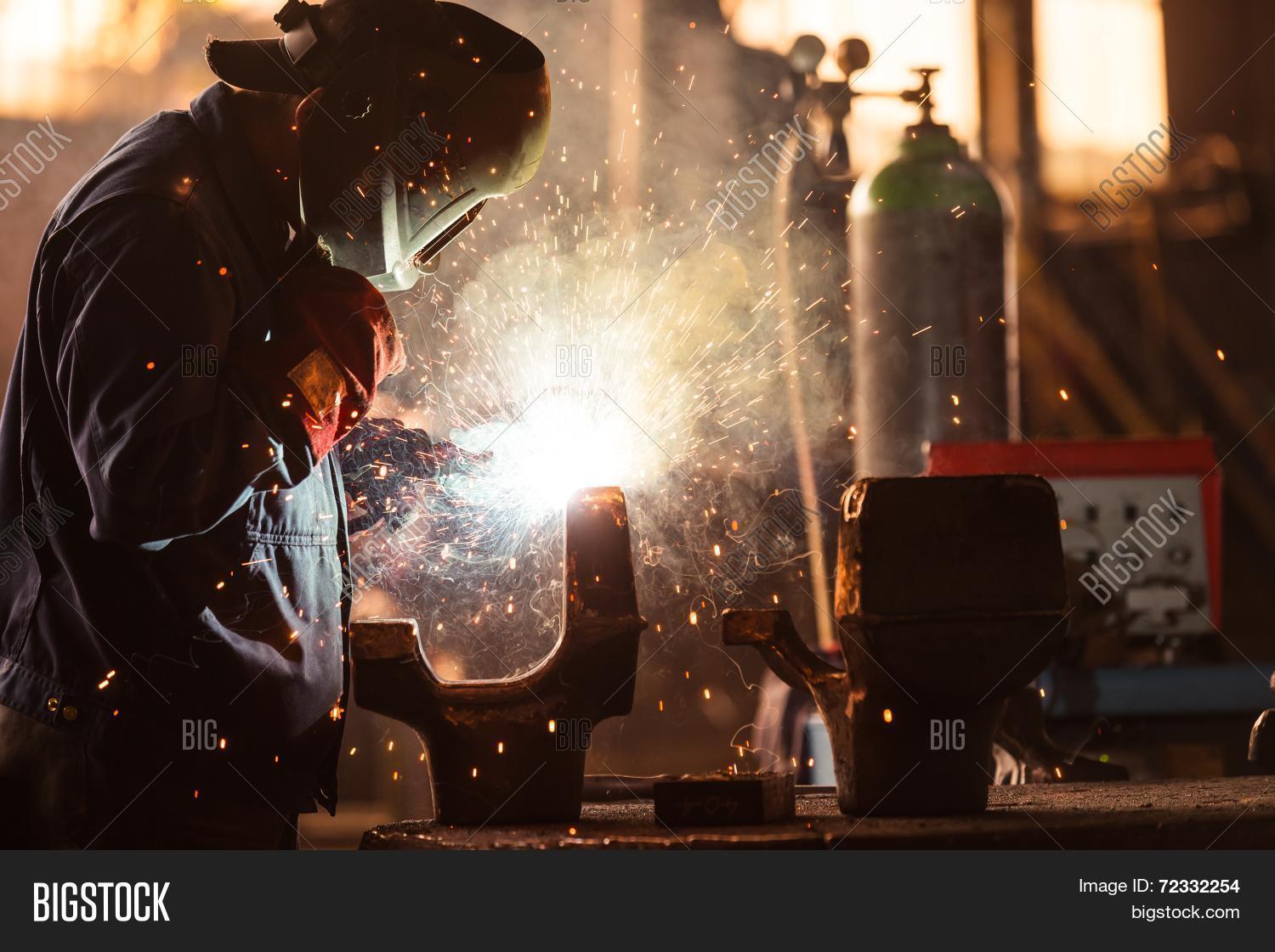 industrial worker at the factory welding closeup