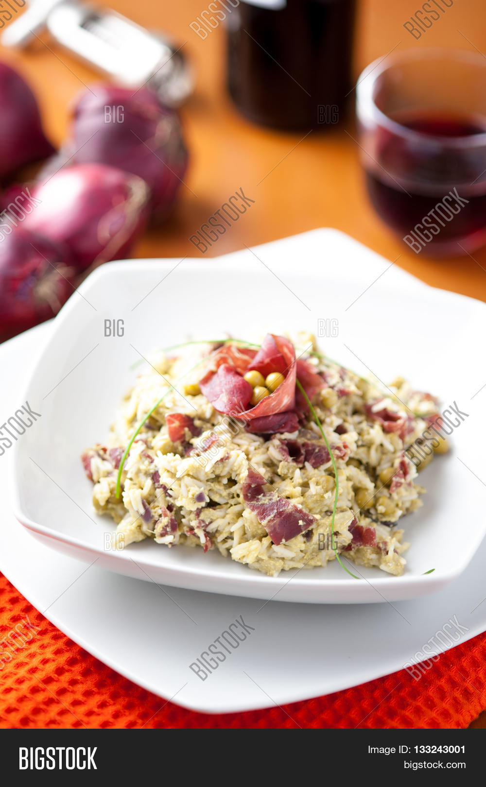 rice dish with asparagus, peas and dried beef, served on a table