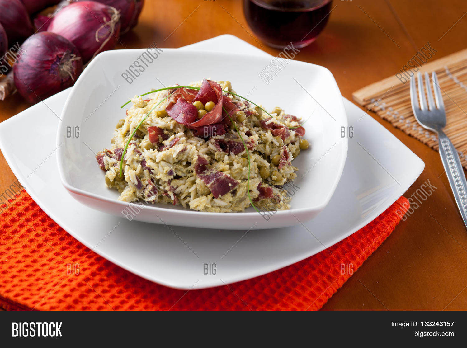 rice dish with asparagus, peas and dried beef, served on a table