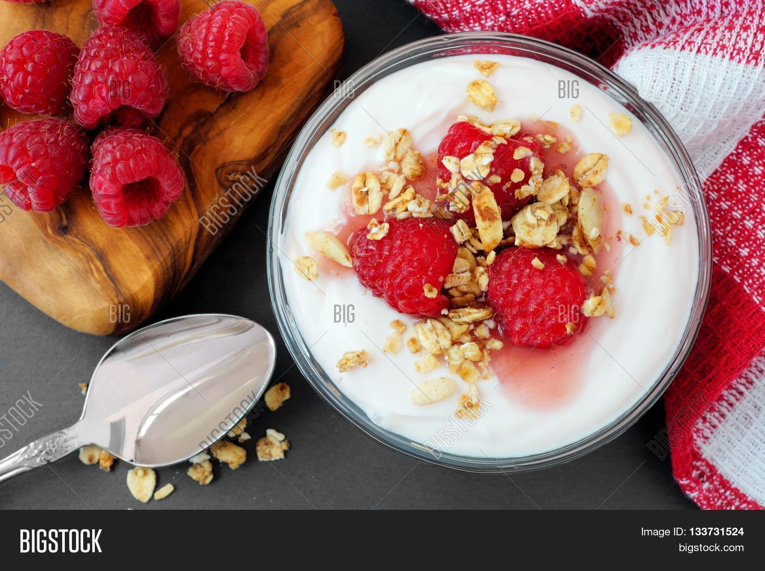 raspberry flavored greek yogurt with granola overhead table