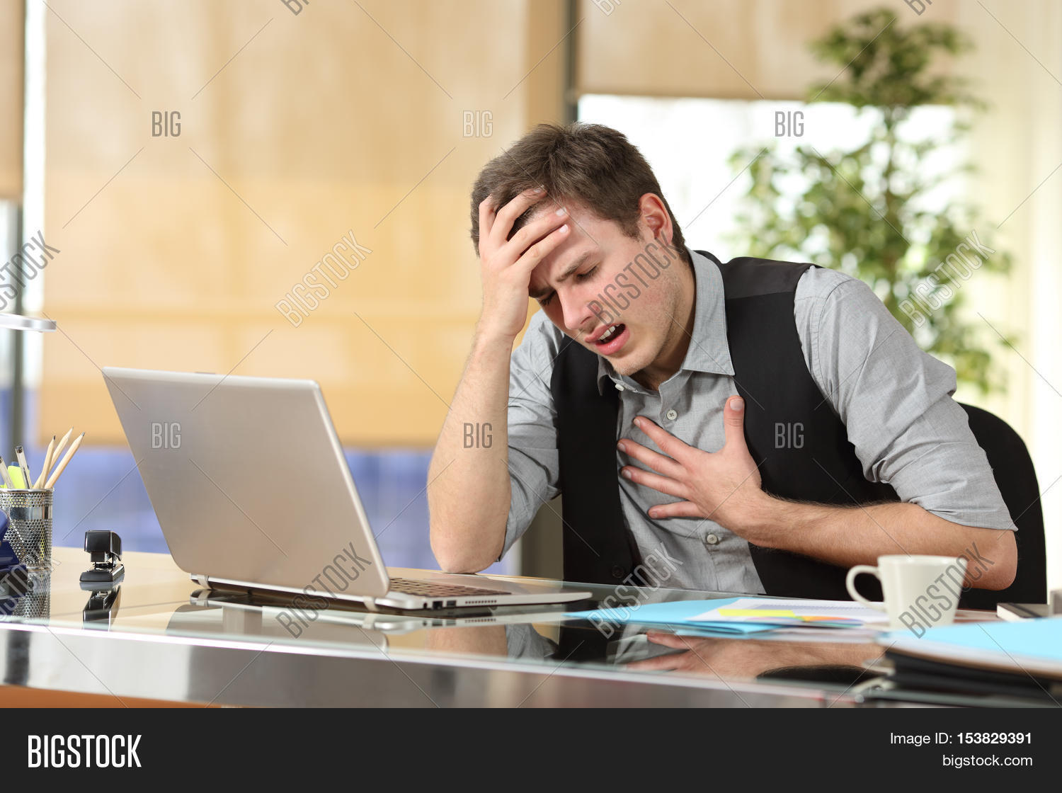 businessman suffering an anxiety attack with the hands in his