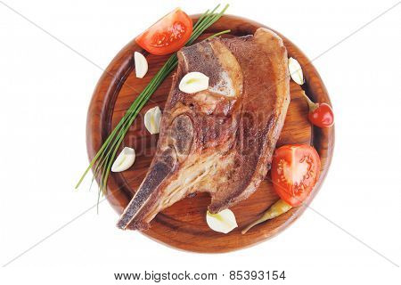 fresh hot roasted beef meat bone steak on red wooden plate with