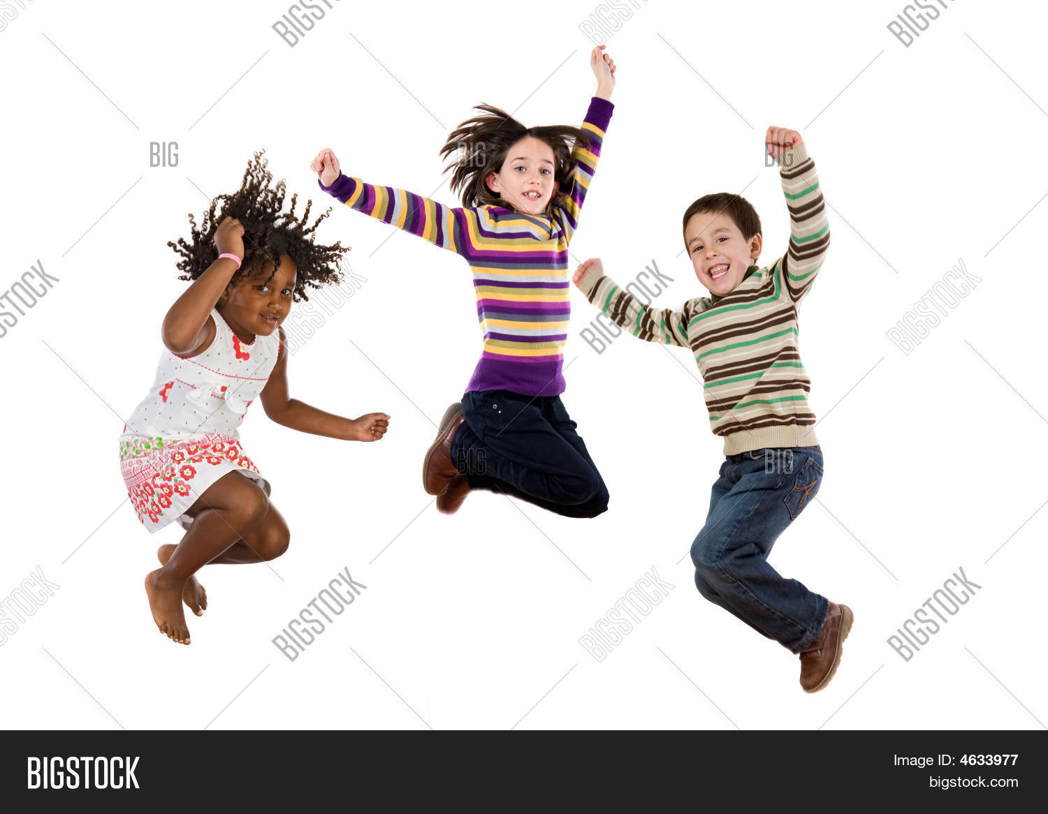three happy children jumping at once on a white background
