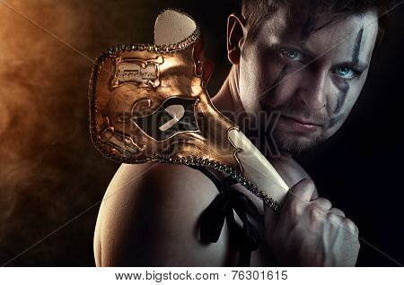 shirtless man dancer or actor with creepy, scary mask