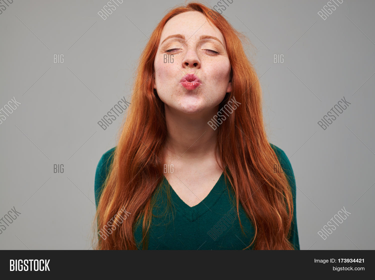 close-up shot of delightful young girl puckering lips at the