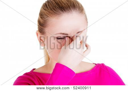 young woman with sinus pressure pain , isolated on white