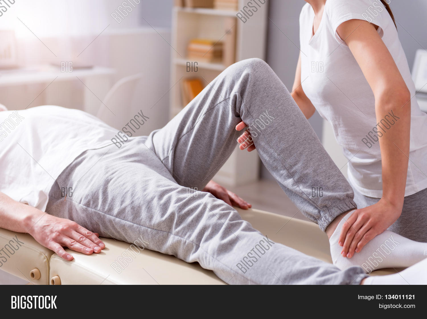 image of male patient lying down with female physiotherapist