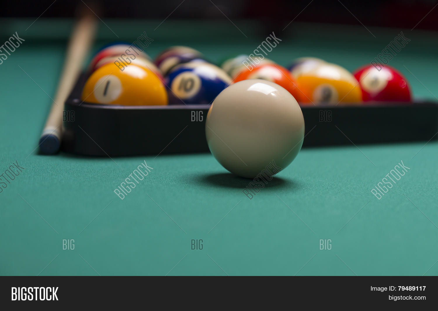 billiard balls arranged in a triangle;selective focus on cue