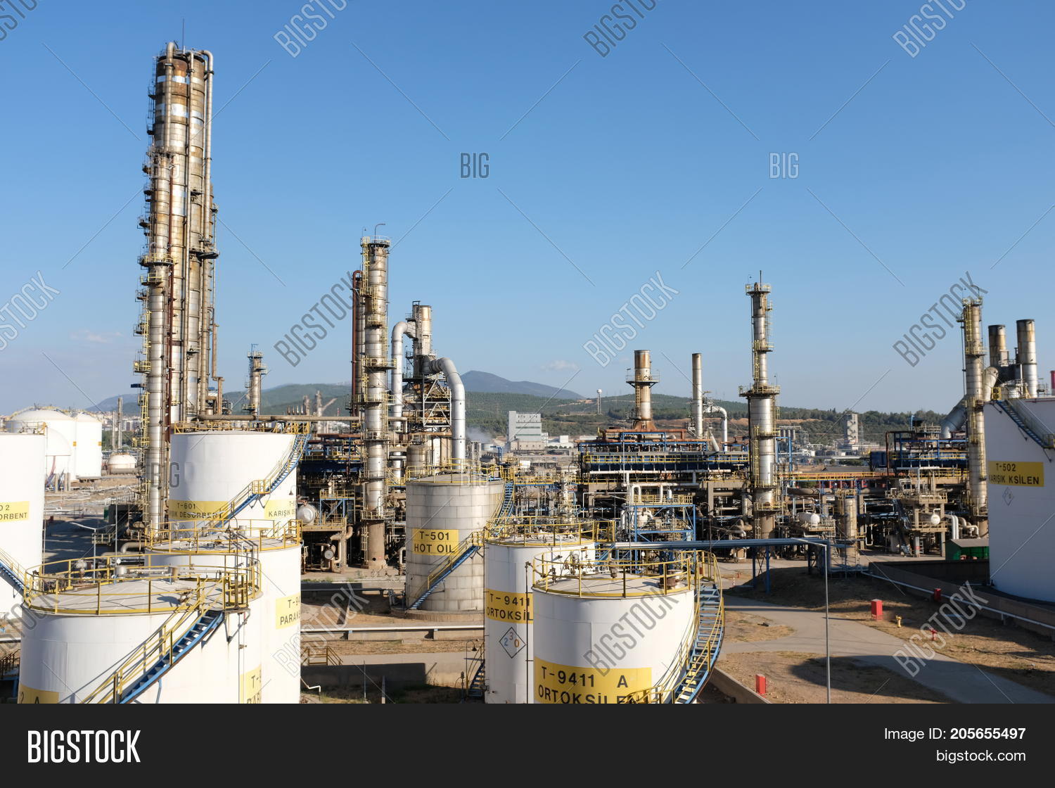 oil refinery view with cranes and various equipment