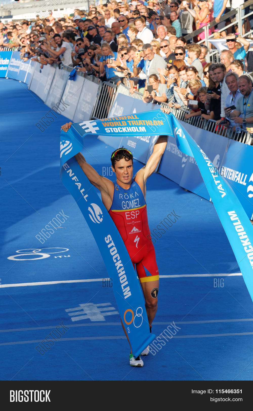 triathlete javier gomez lifting the finnish line when winning