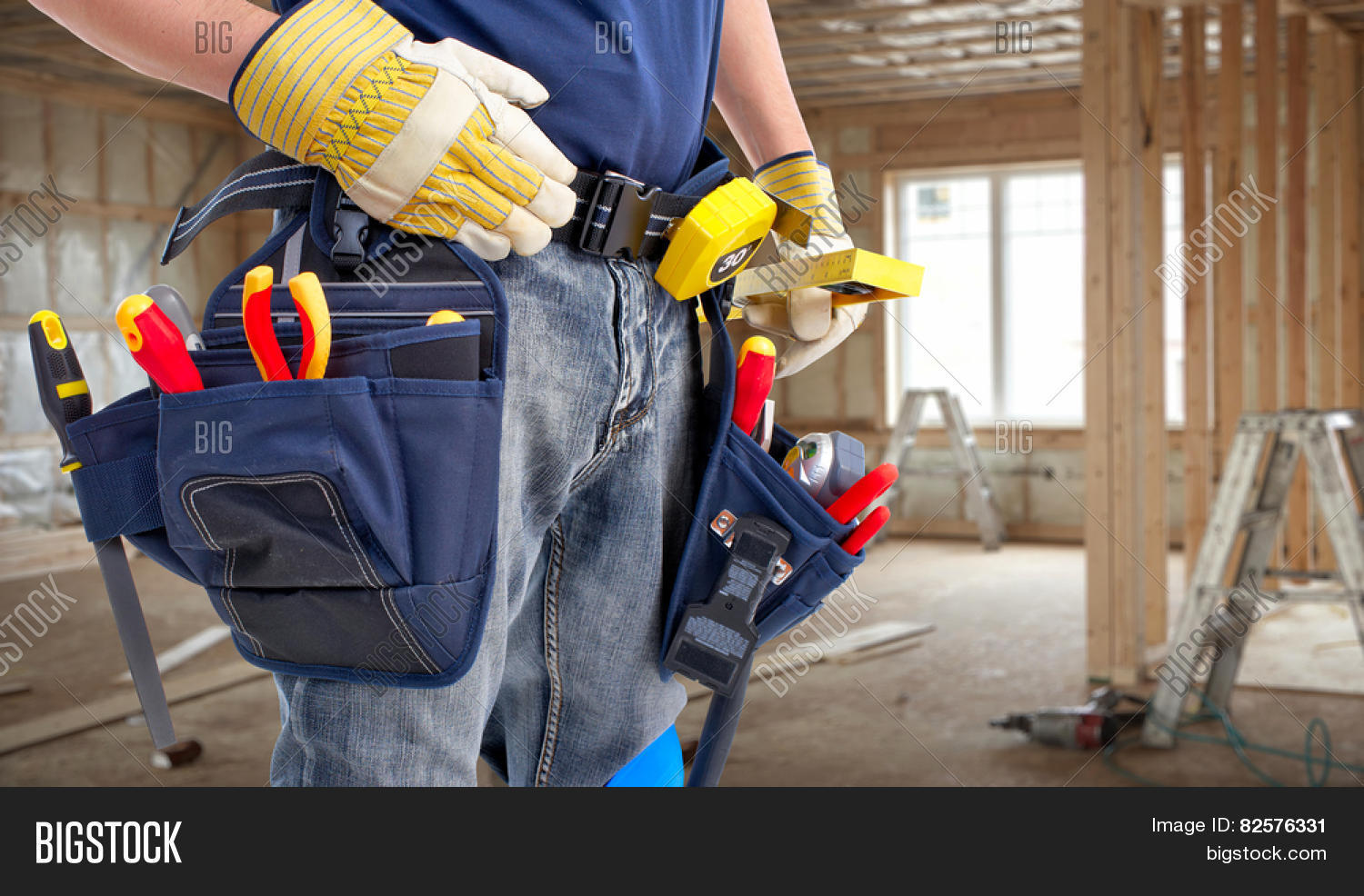 worker with construction tools. house renovation background.