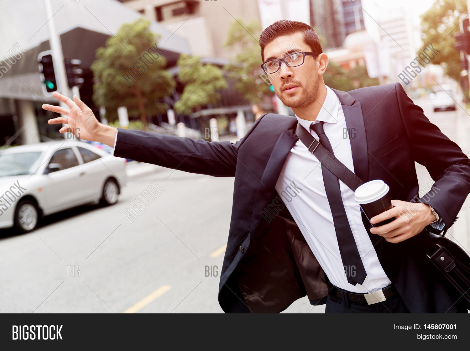 young businessmen hailing for a taxi