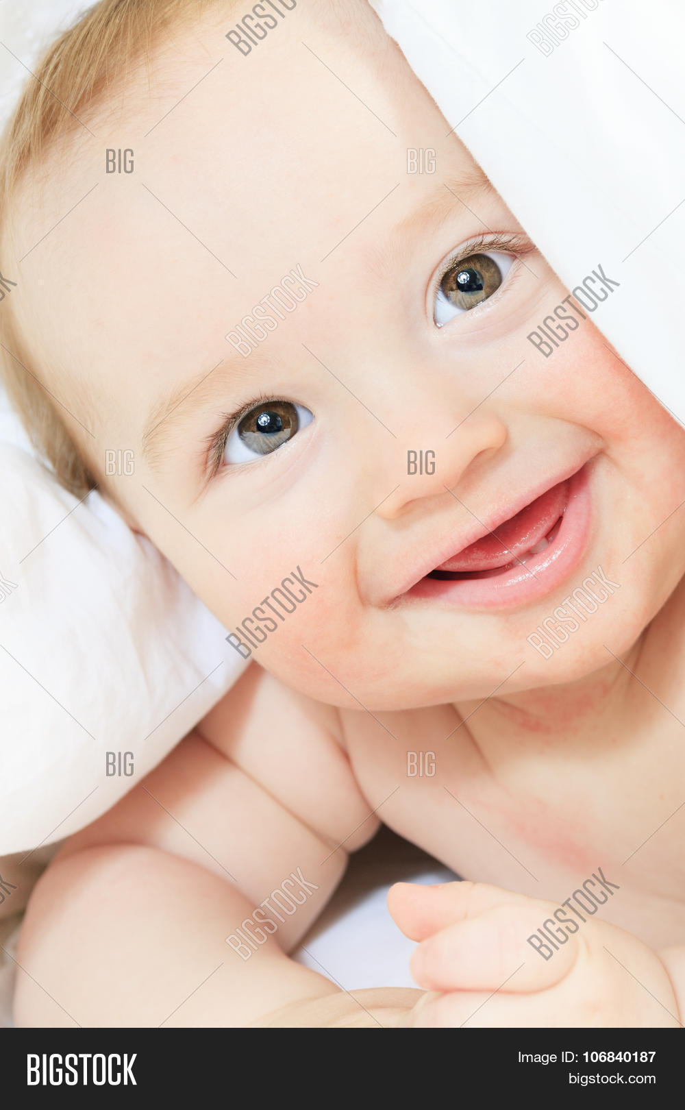 a baby boy playing on the parent bed