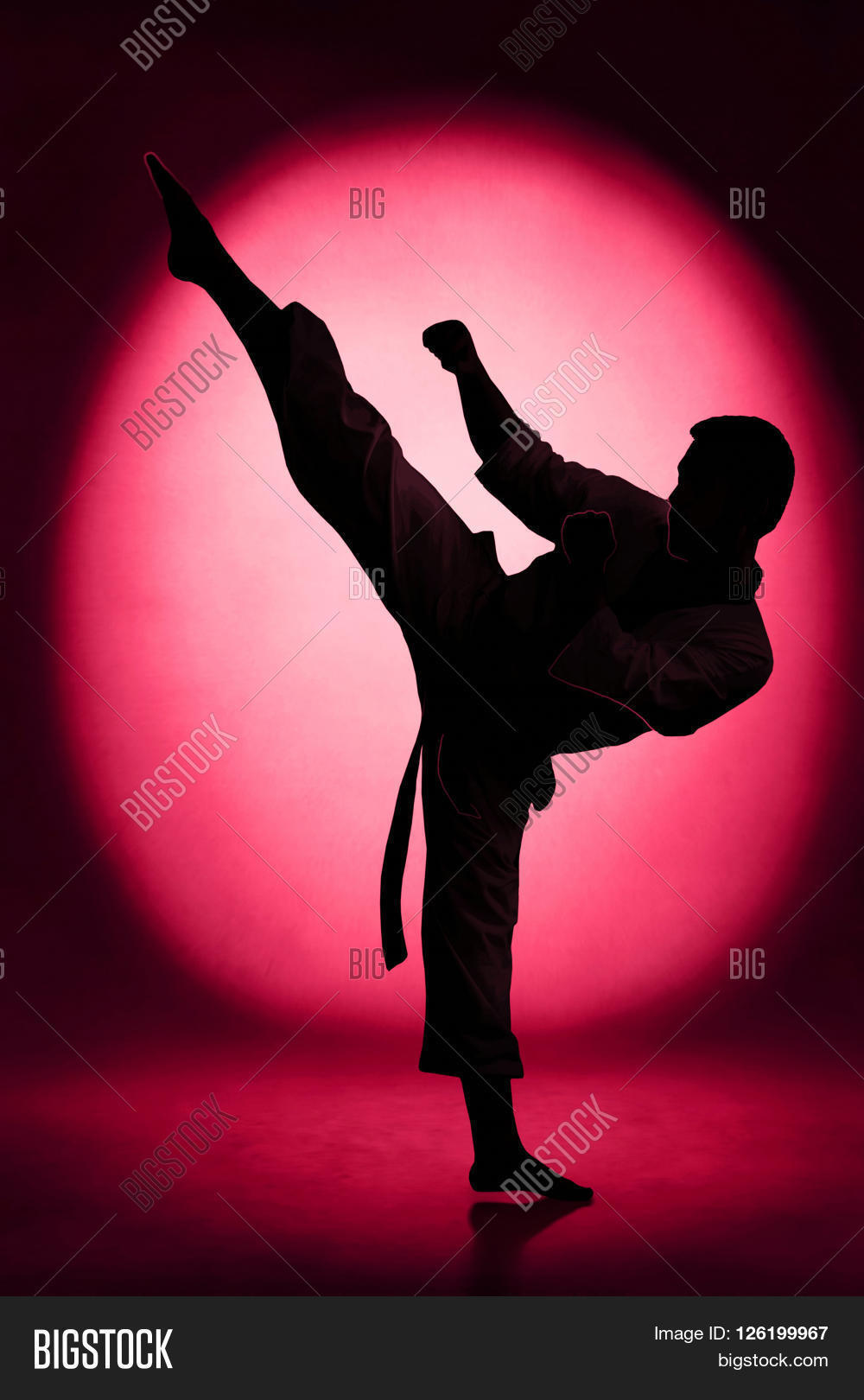 silhouette of man karate kick