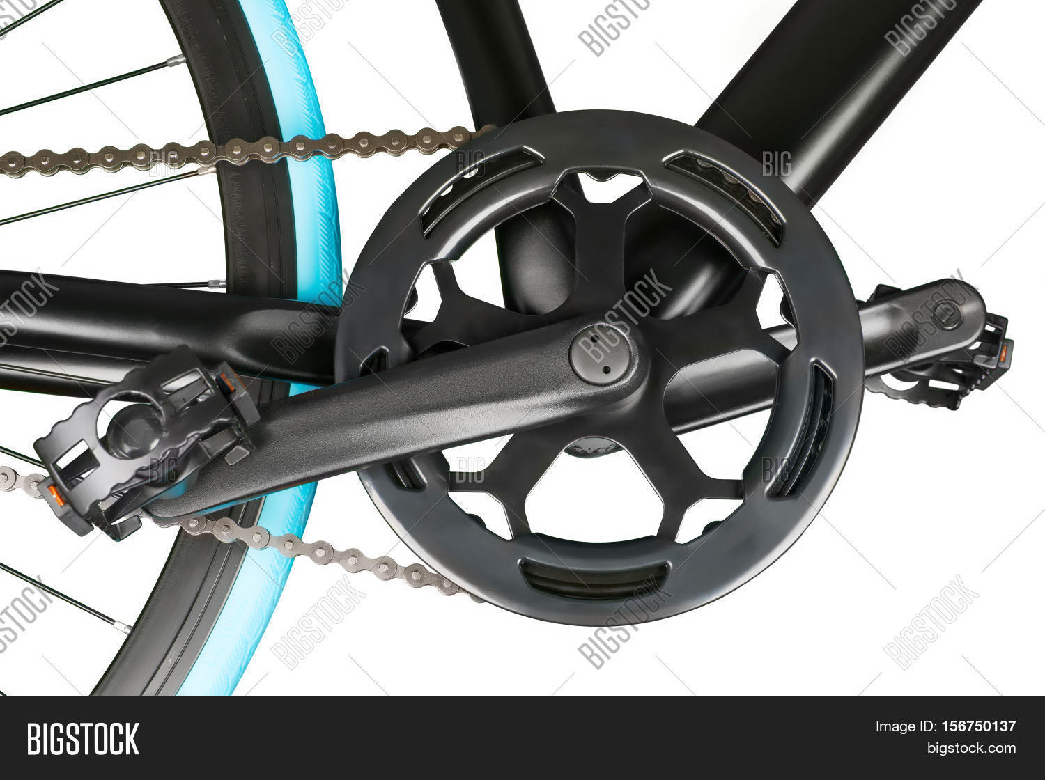 close up of black bike crankset chainring and pedals.
