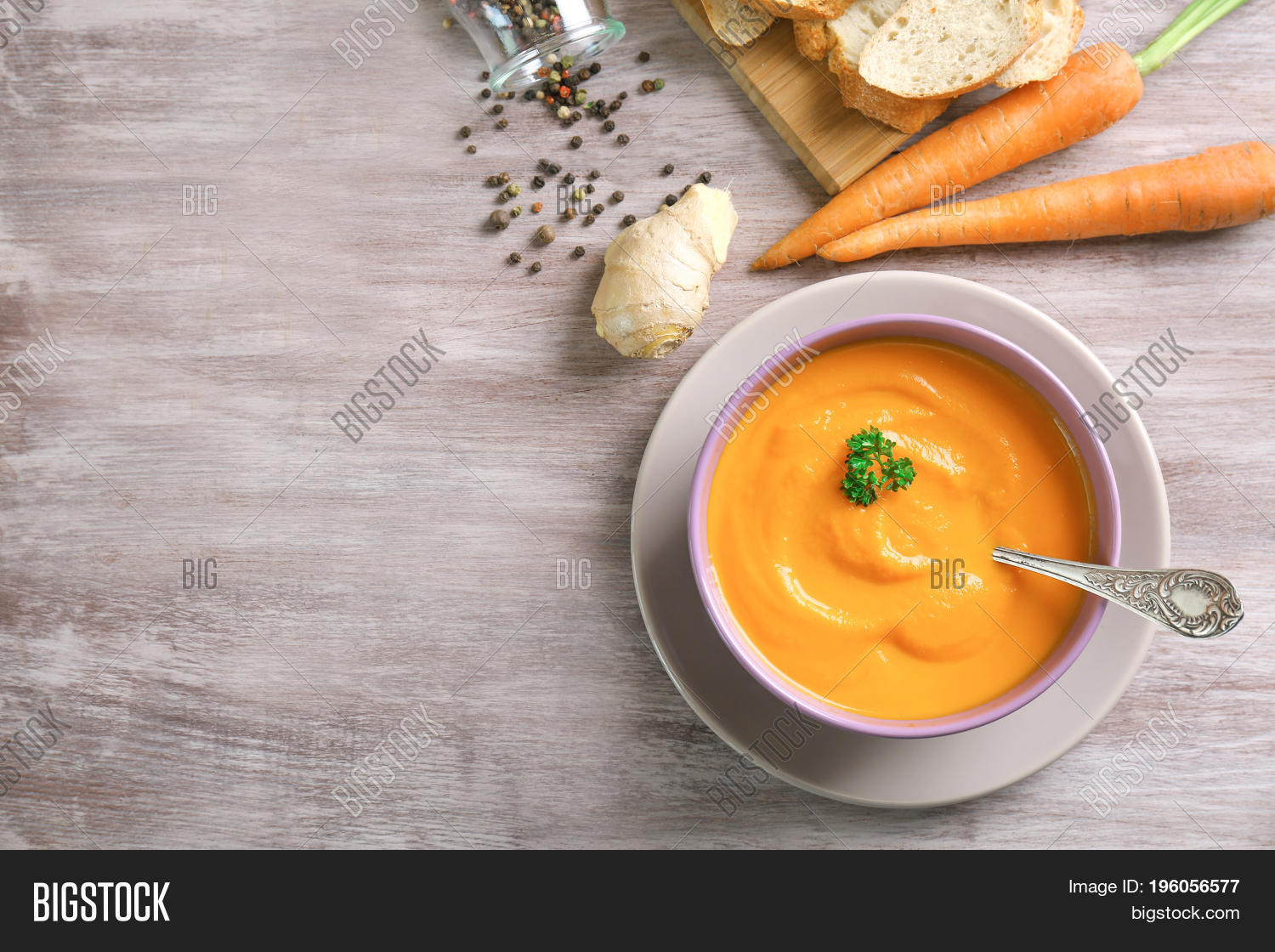 composition with delicious carrot soup and fresh ginger on