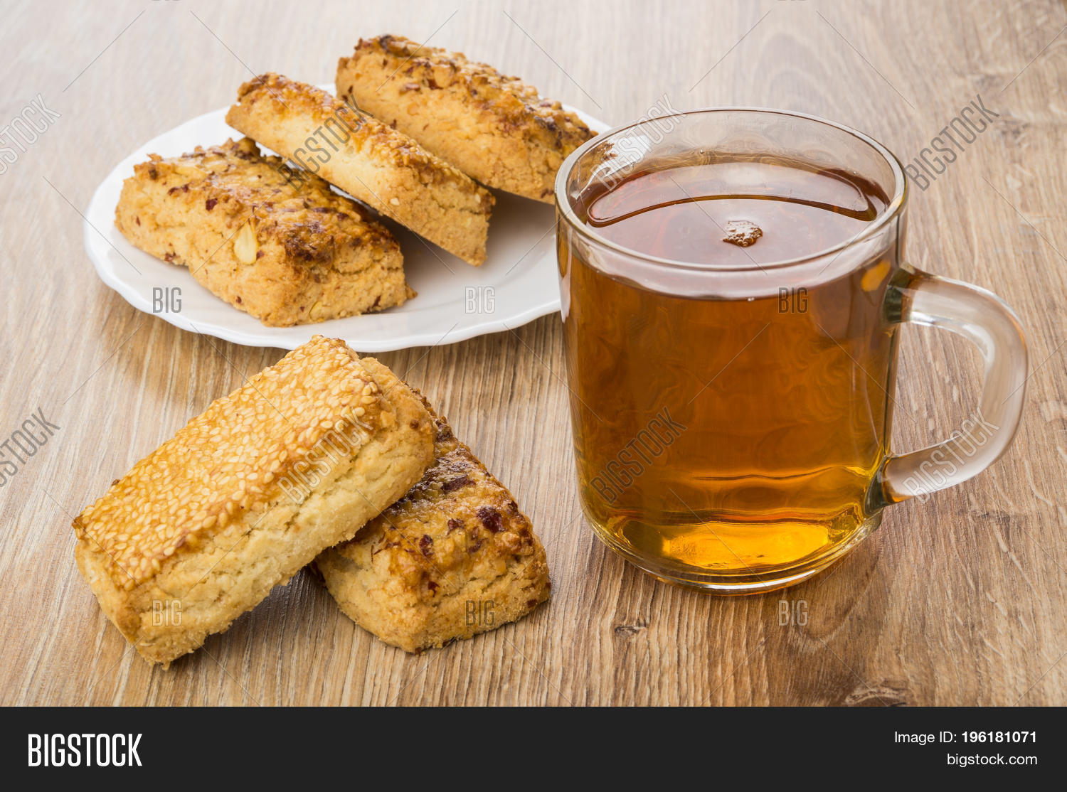shortbreads with nuts and sesame and transparent cup with tea on