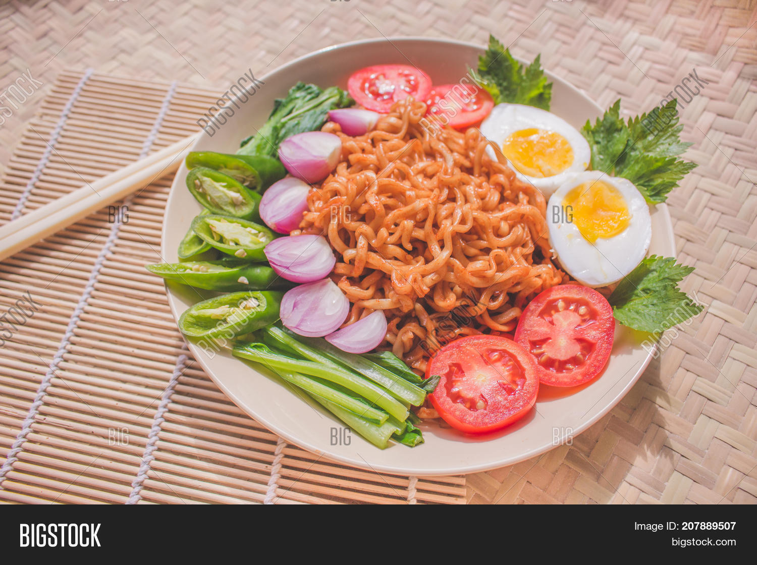 delicious fried noodles on unique bamboo woven table