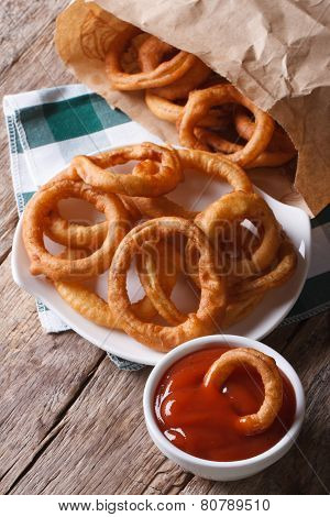 fried onion rings and ketchup closeup. vertical top view