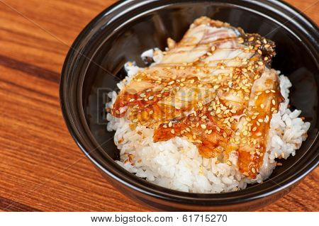 japanese cuisine, eel with rice at black plate