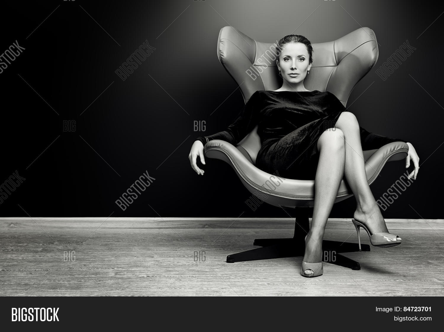portrait of a stunning fashionable model sitting in a chair in
