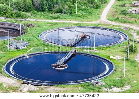 aerial view of water treatment plant with round settlers