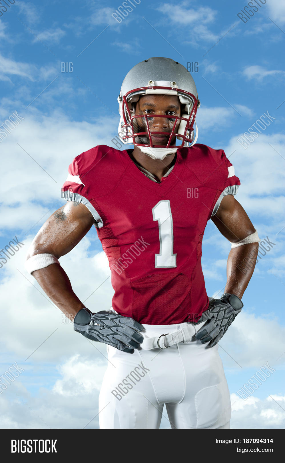 black football player with hands on hips