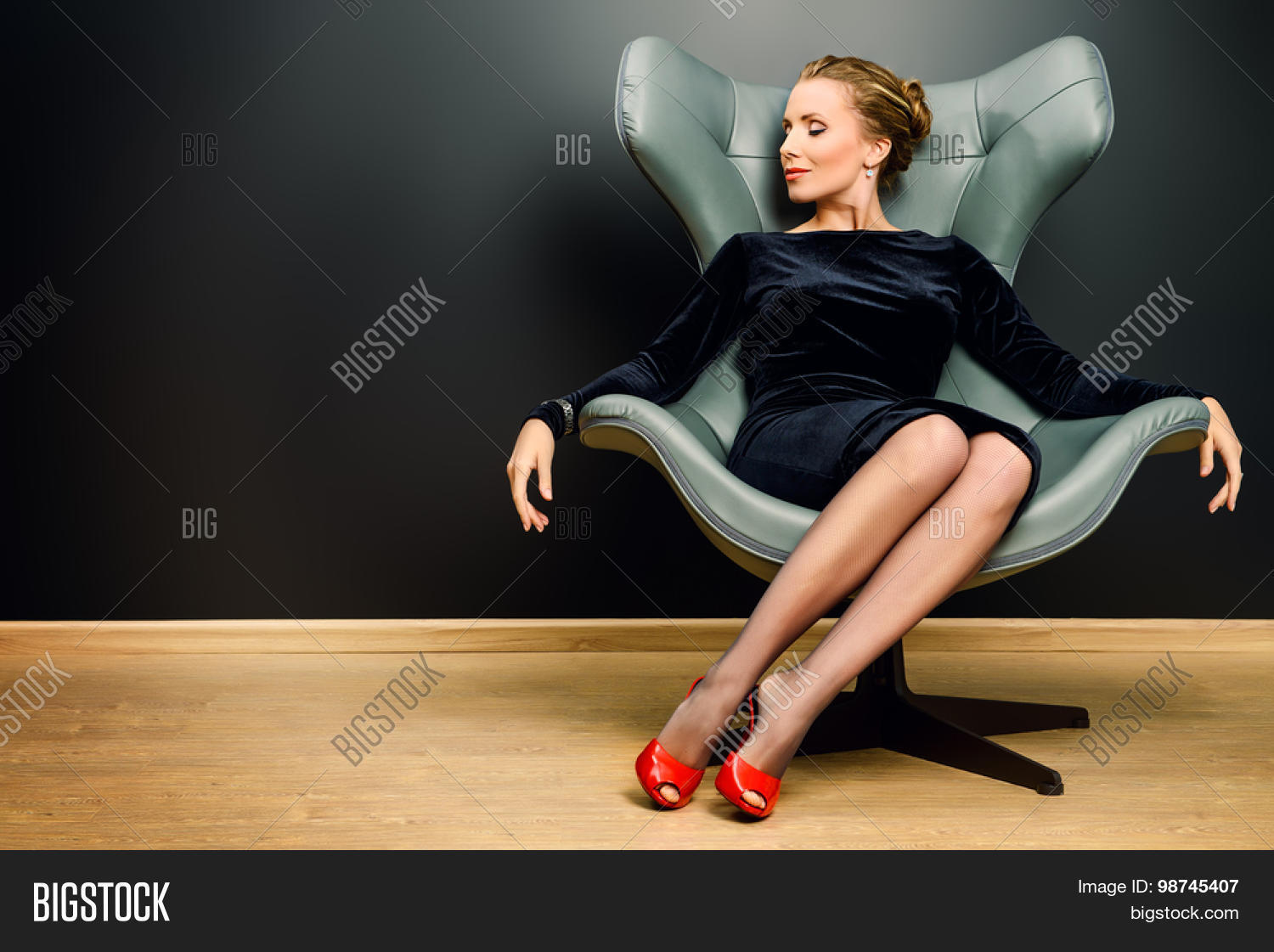 portrait of a stunning fashionable model sitting in a chair in