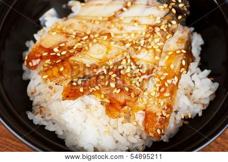 japanese cuisine, eel with rice at black plate