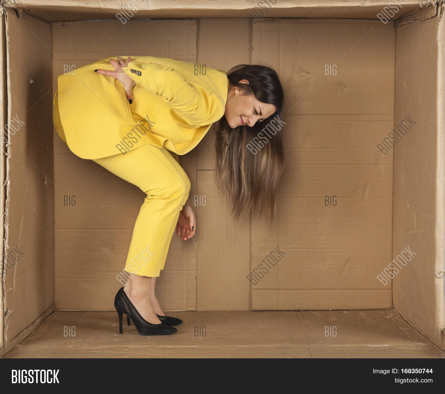 woman has a sore back from staying in a cramped room