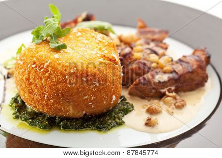 fried pork with potato-scramble garnish and nuts sauce