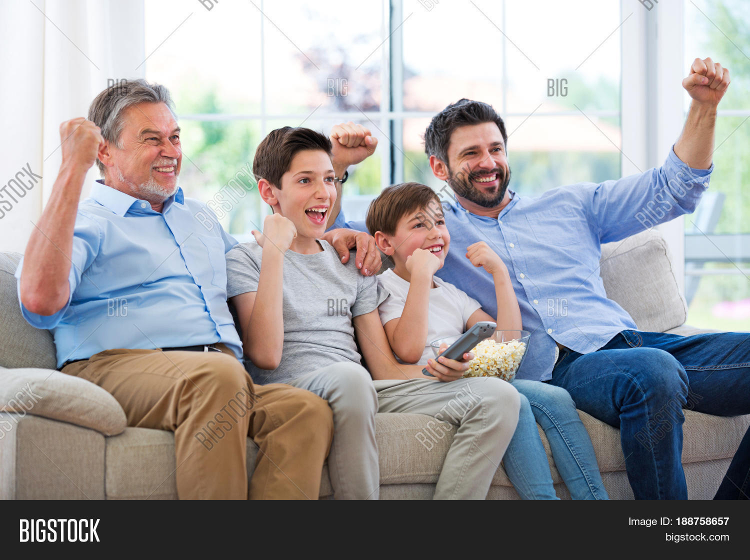 family of three generations watching tv